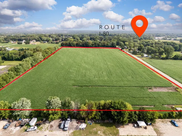a view of a street with lots of trees and buildings in the background