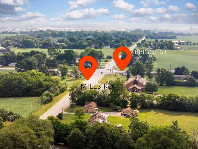 a view of a city with lots of residential buildings lake and mountain view