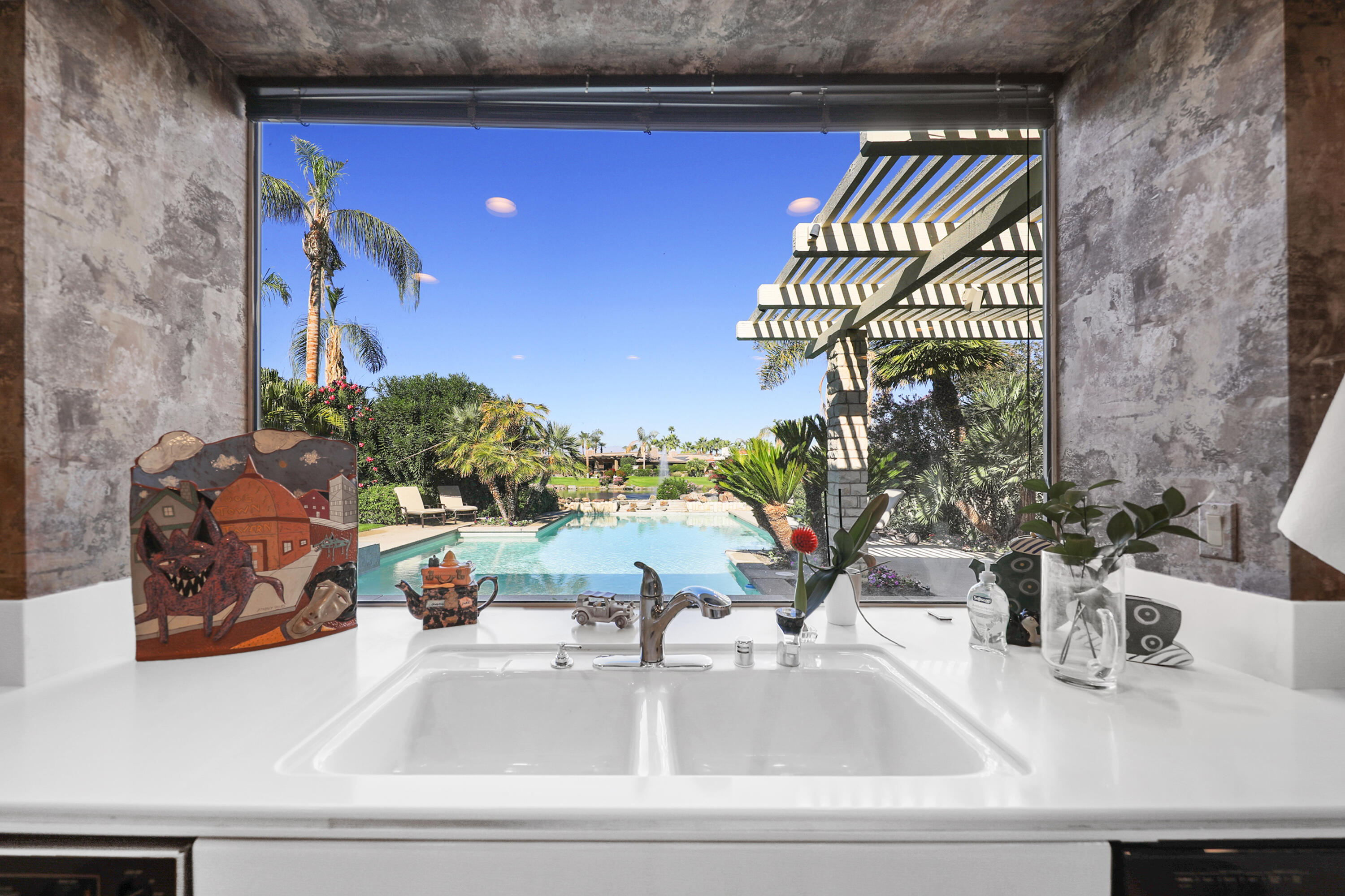 44 Fincher Way Rancho Mirage, CA 92270 - Photo 23 of 56 a kitchen sink with granite countertop a sink and a stove