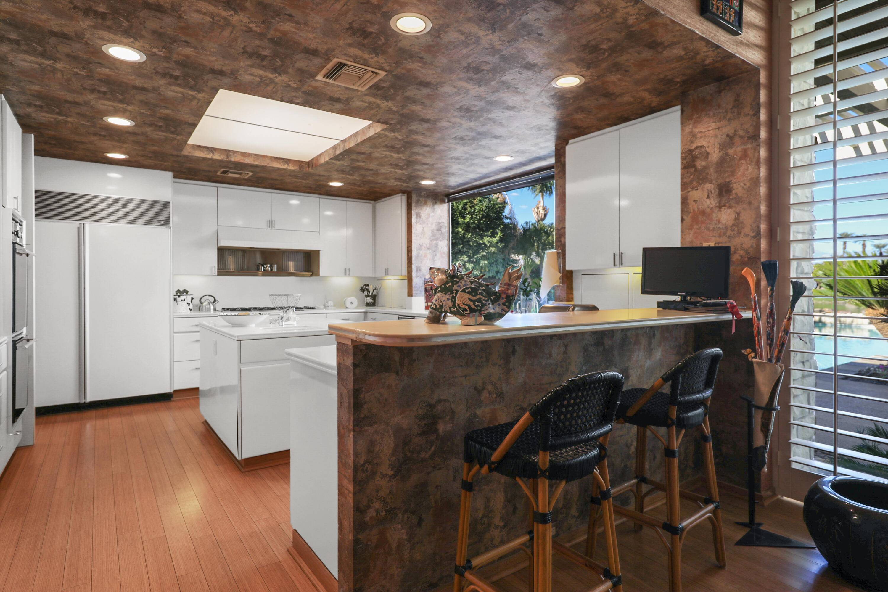 44 Fincher Way Rancho Mirage, CA 92270 - Photo 26 of 56 a kitchen with a table chairs refrigerator and microwave