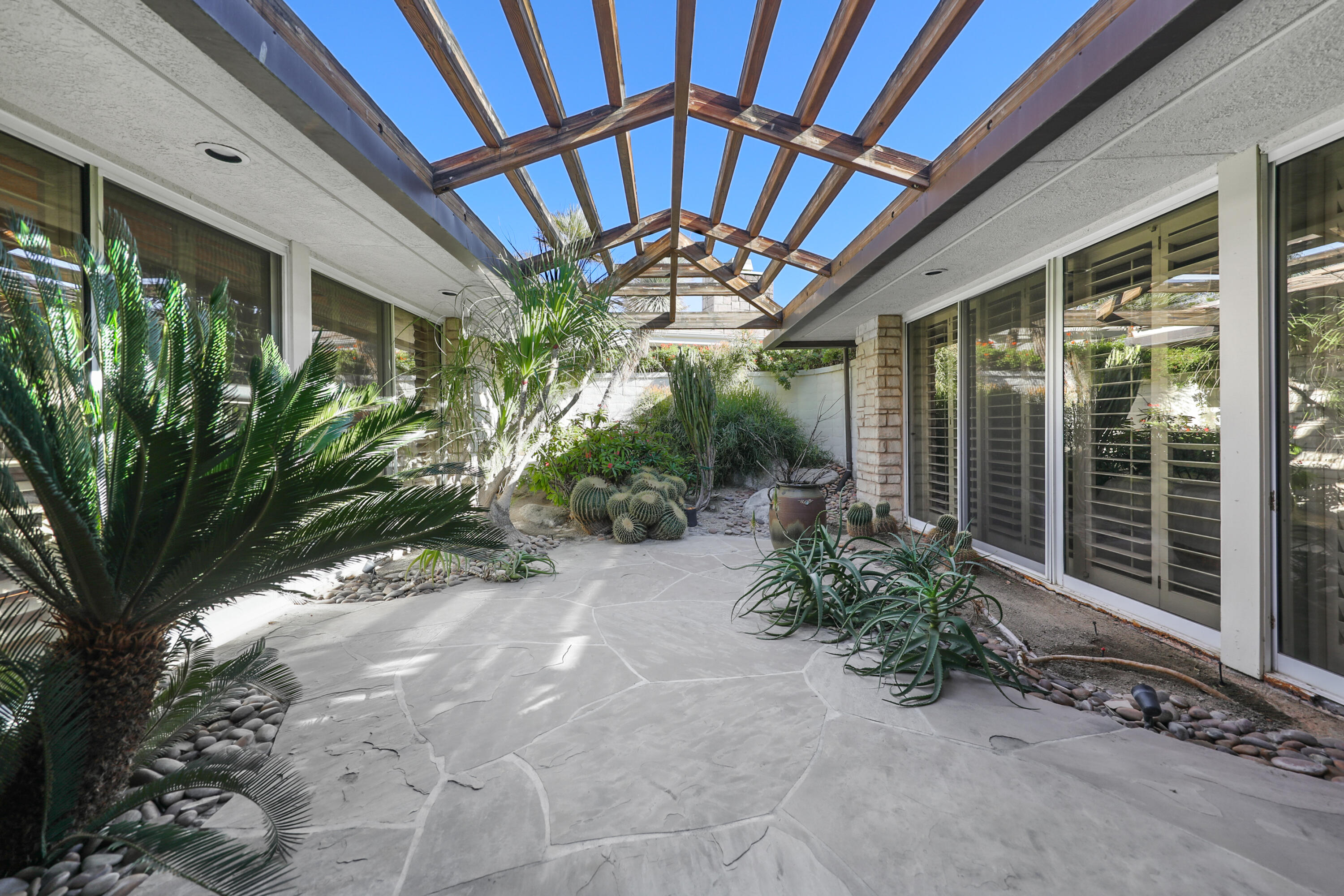 44 Fincher Way Rancho Mirage, CA 92270 - Photo 38 of 56 a view of a porch with a garden