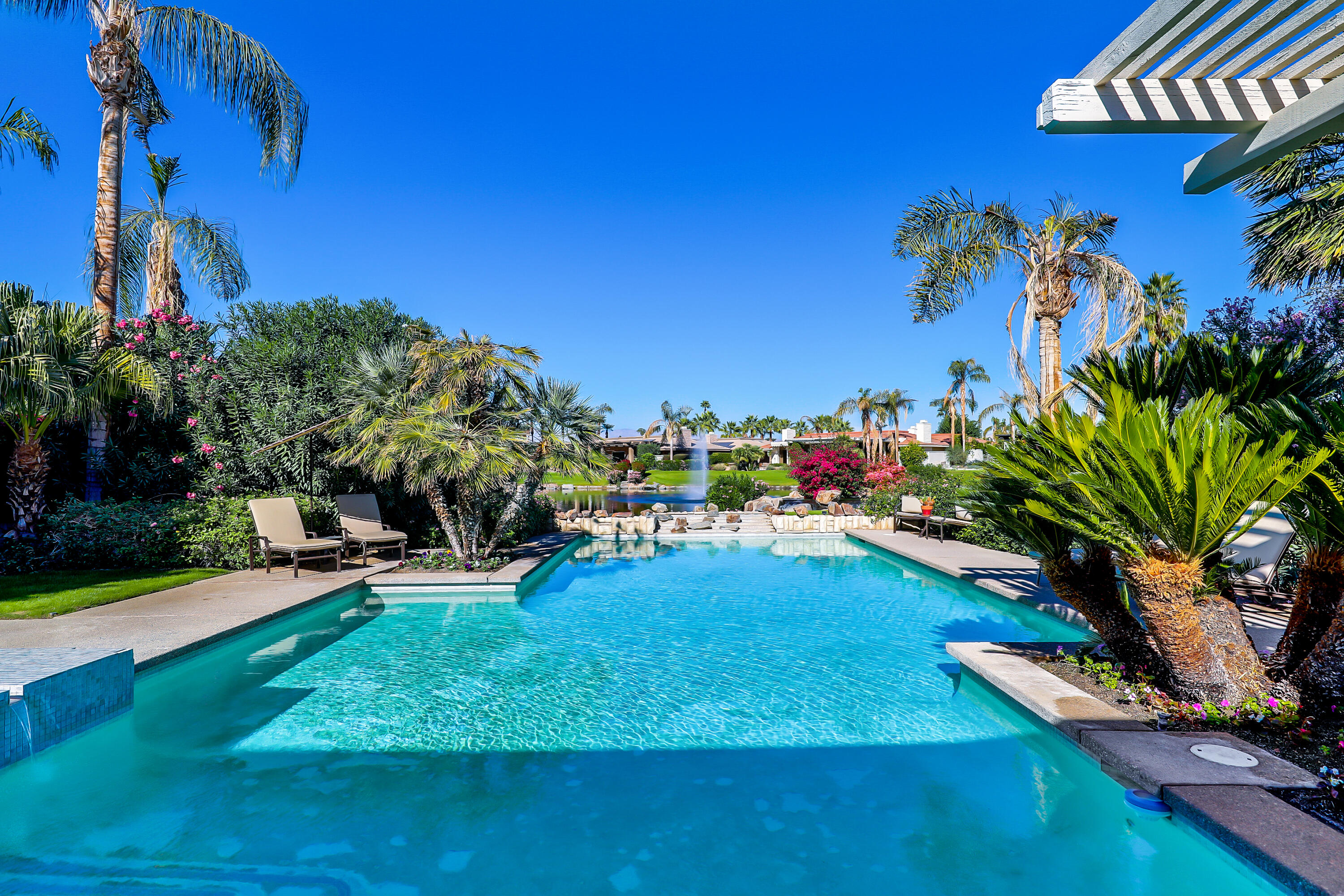 44 Fincher Way Rancho Mirage, CA 92270 - Photo 40 of 56 a view of a swimming pool with a yard and sitting area