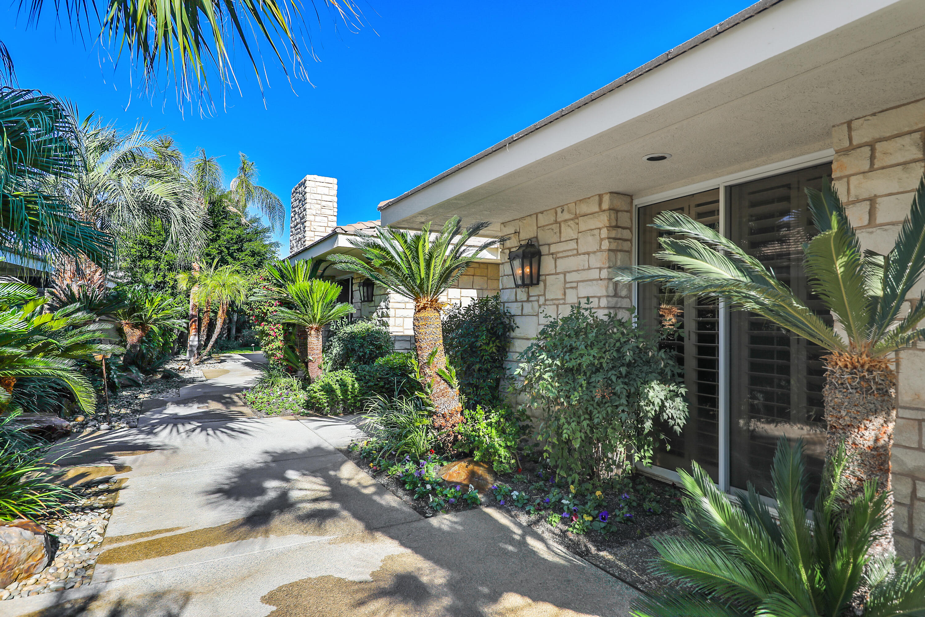 44 Fincher Way Rancho Mirage, CA 92270 - Photo 5 of 56 a plant is in front of a house