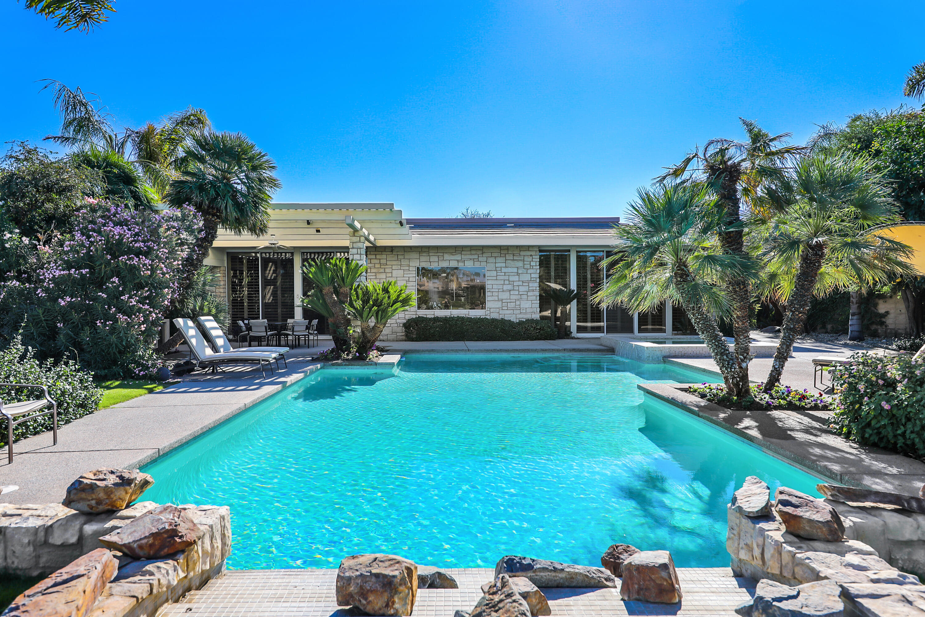 44 Fincher Way Rancho Mirage, CA 92270 - Photo 45 of 56 a front view of a house with garden