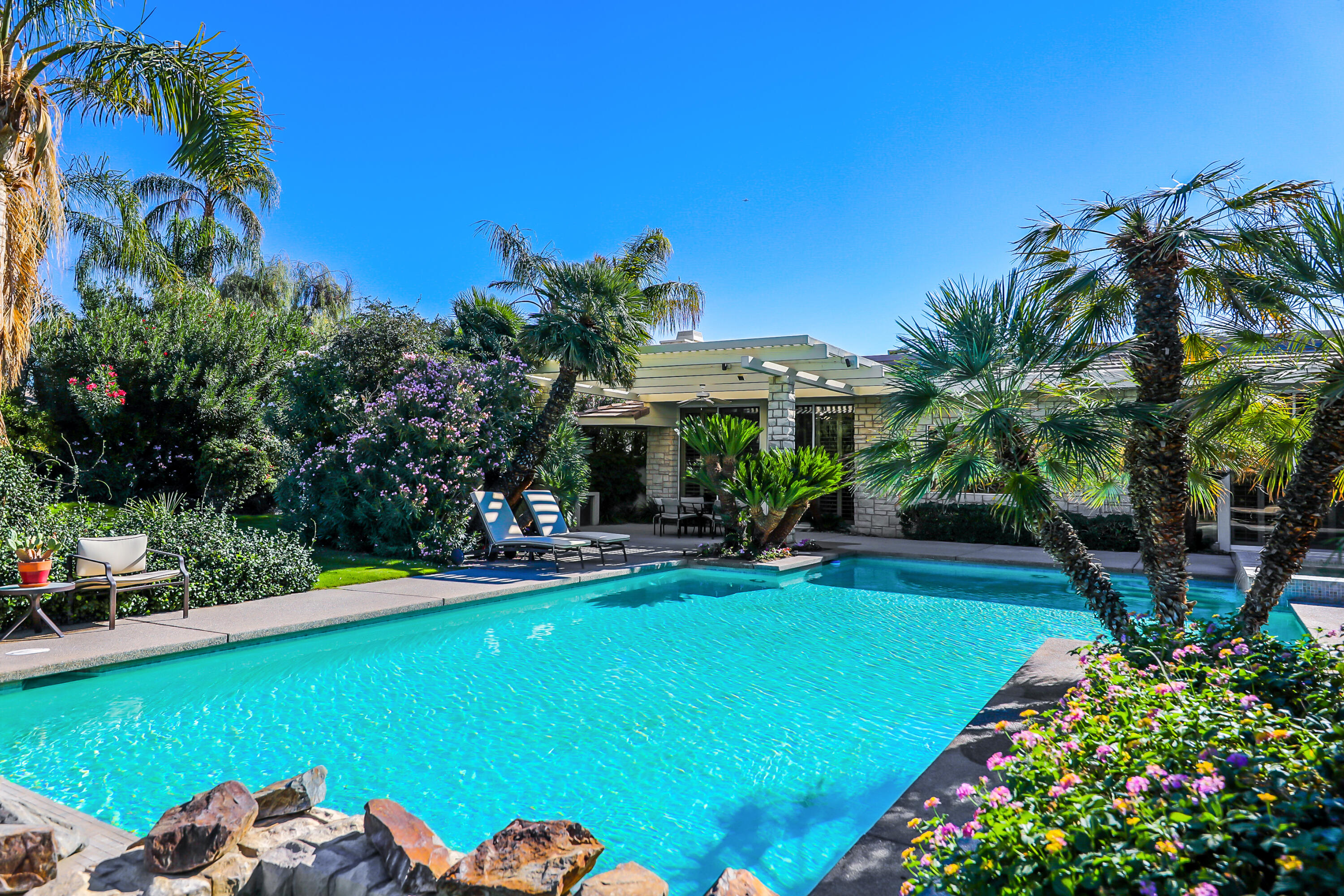 44 Fincher Way Rancho Mirage, CA 92270 - Photo 50 of 56 a view of a swimming pool with a patio and a yard