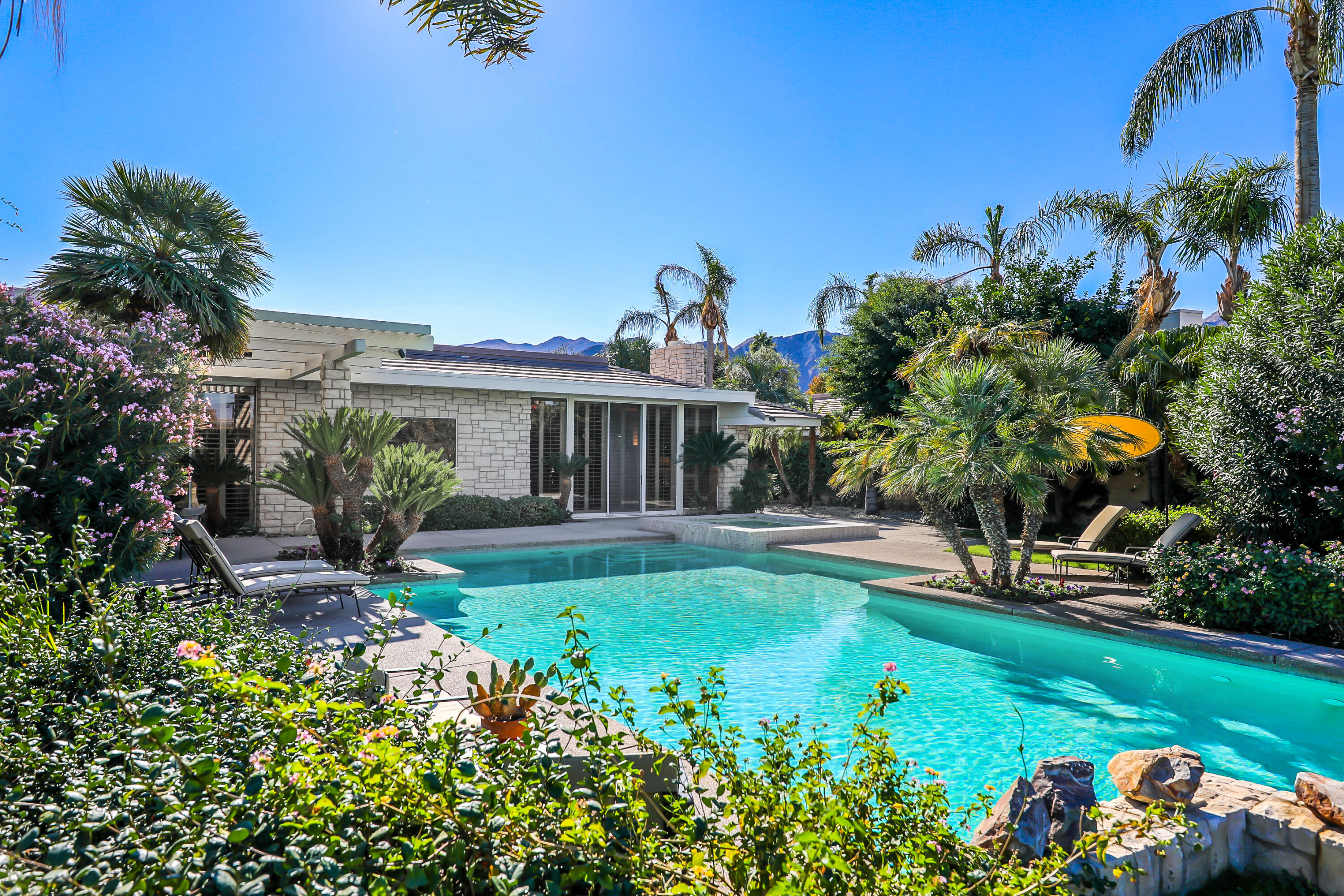 44 Fincher Way Rancho Mirage, CA 92270 - Photo 51 of 56 a front view of a house with a garden
