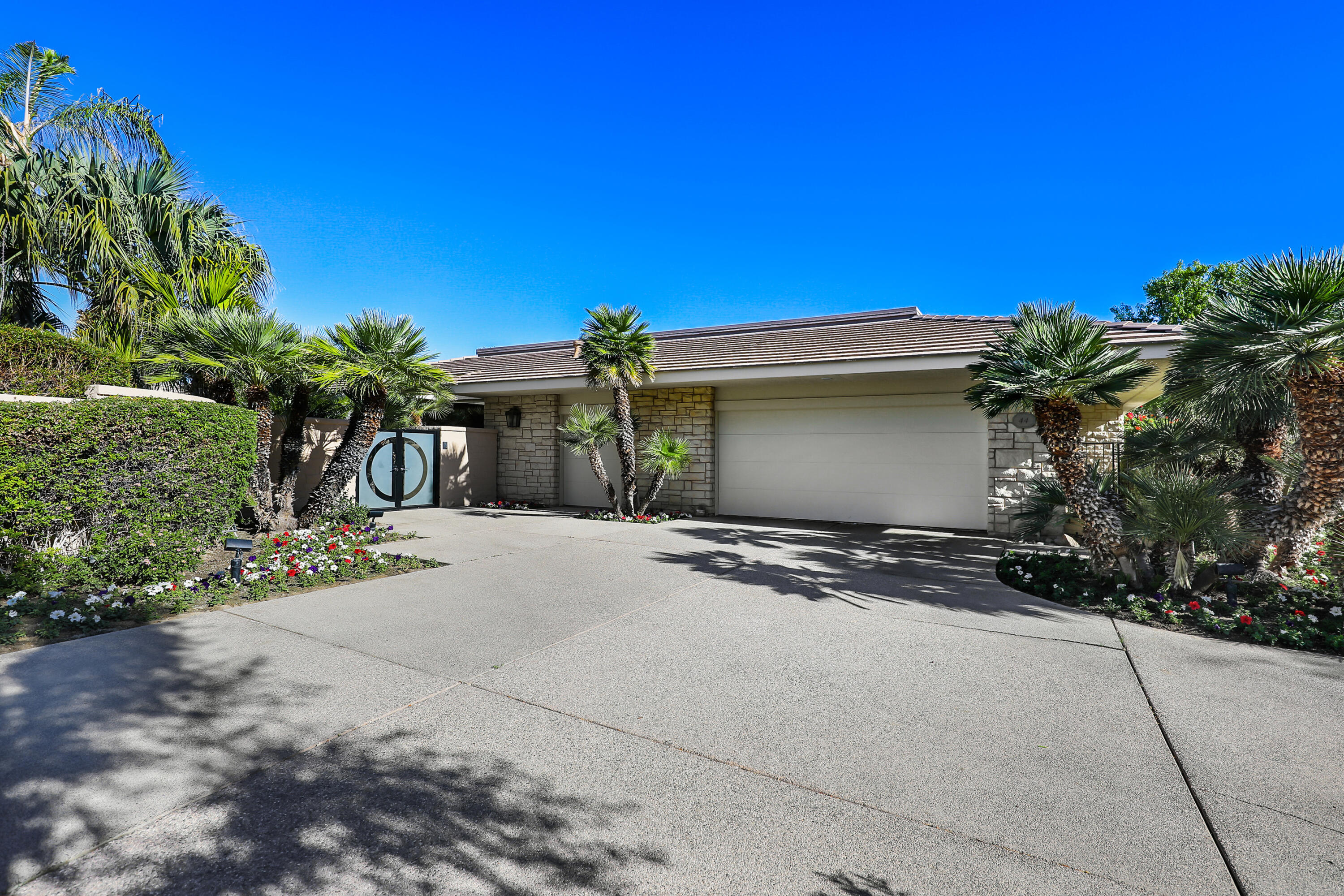 44 Fincher Way Rancho Mirage, CA 92270 - Photo 55 of 56 a view of a house with a yard and a garage
