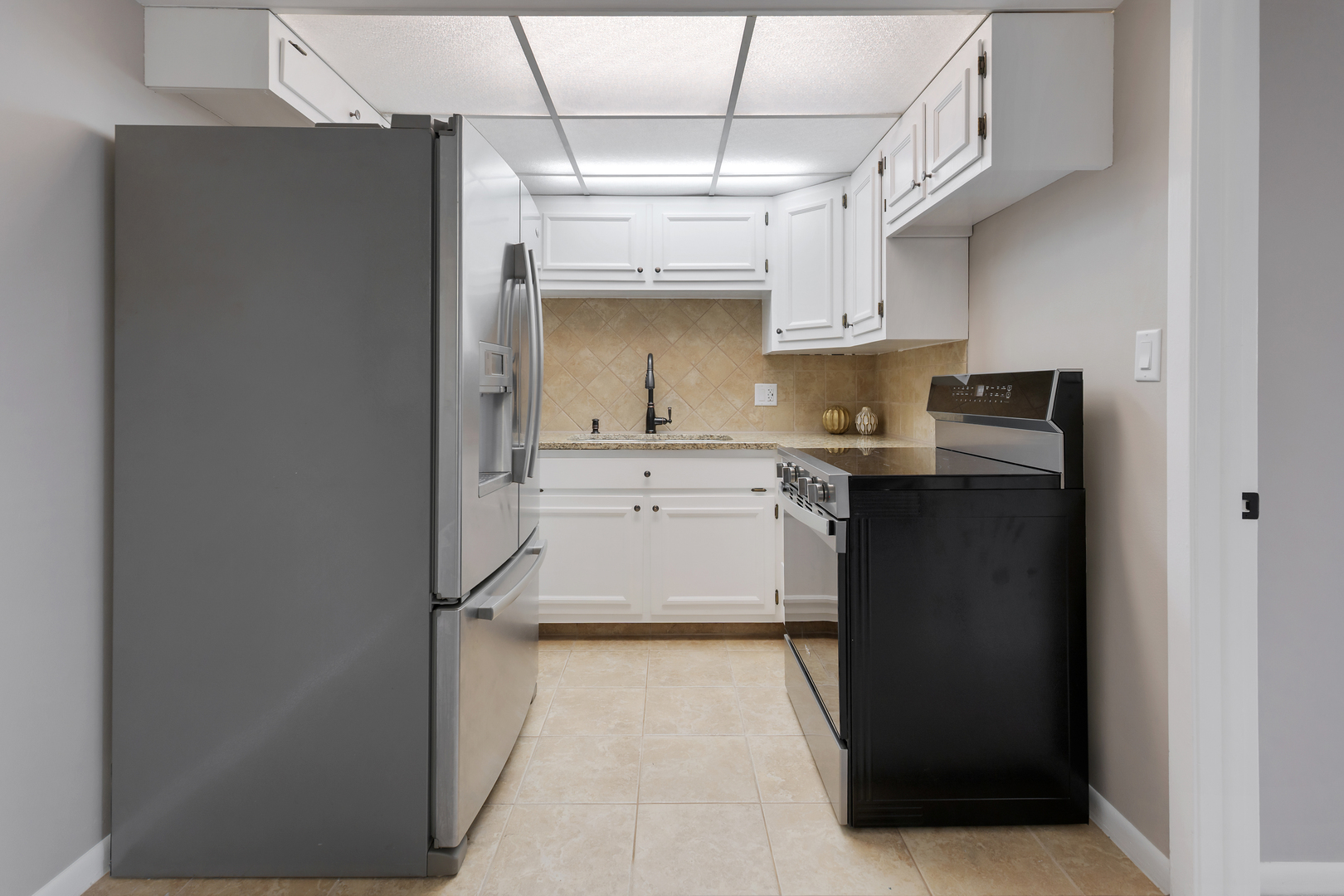 2900 Maple Avenue, Unit 17E Downers Grove, IL 60515 - Photo 11 of 19 a kitchen with stainless steel appliances granite countertop a refrigerator a sink and dishwasher