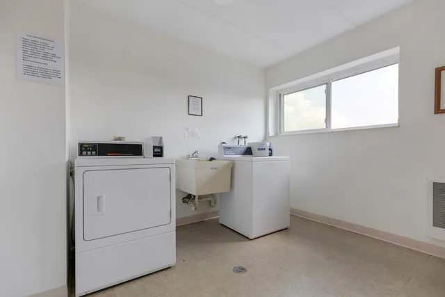 a view of a workspace with furniture and window