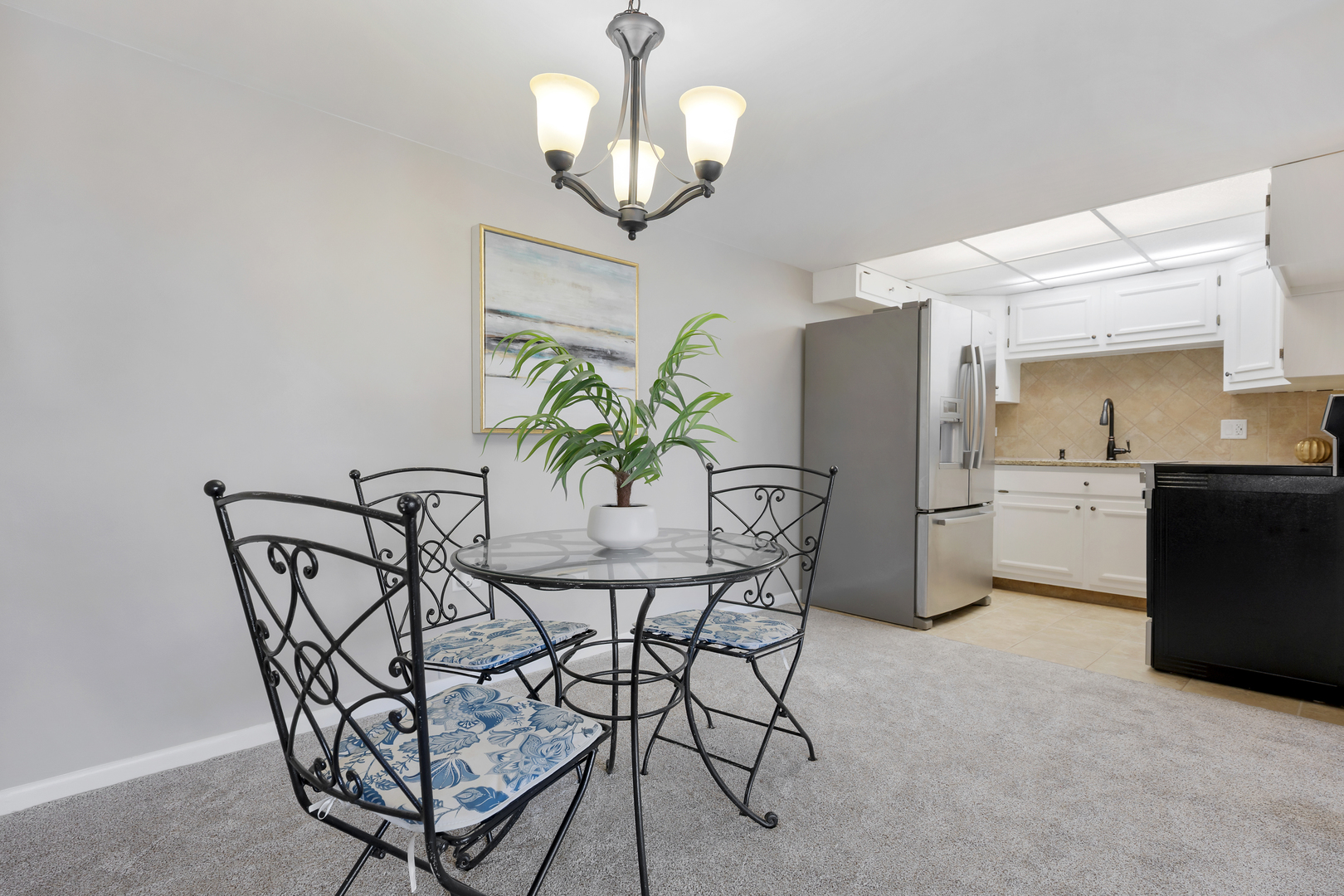 2900 Maple Avenue, Unit 17E Downers Grove, IL 60515 - Photo 9 of 19 a view of a dining room with furniture and chandelier