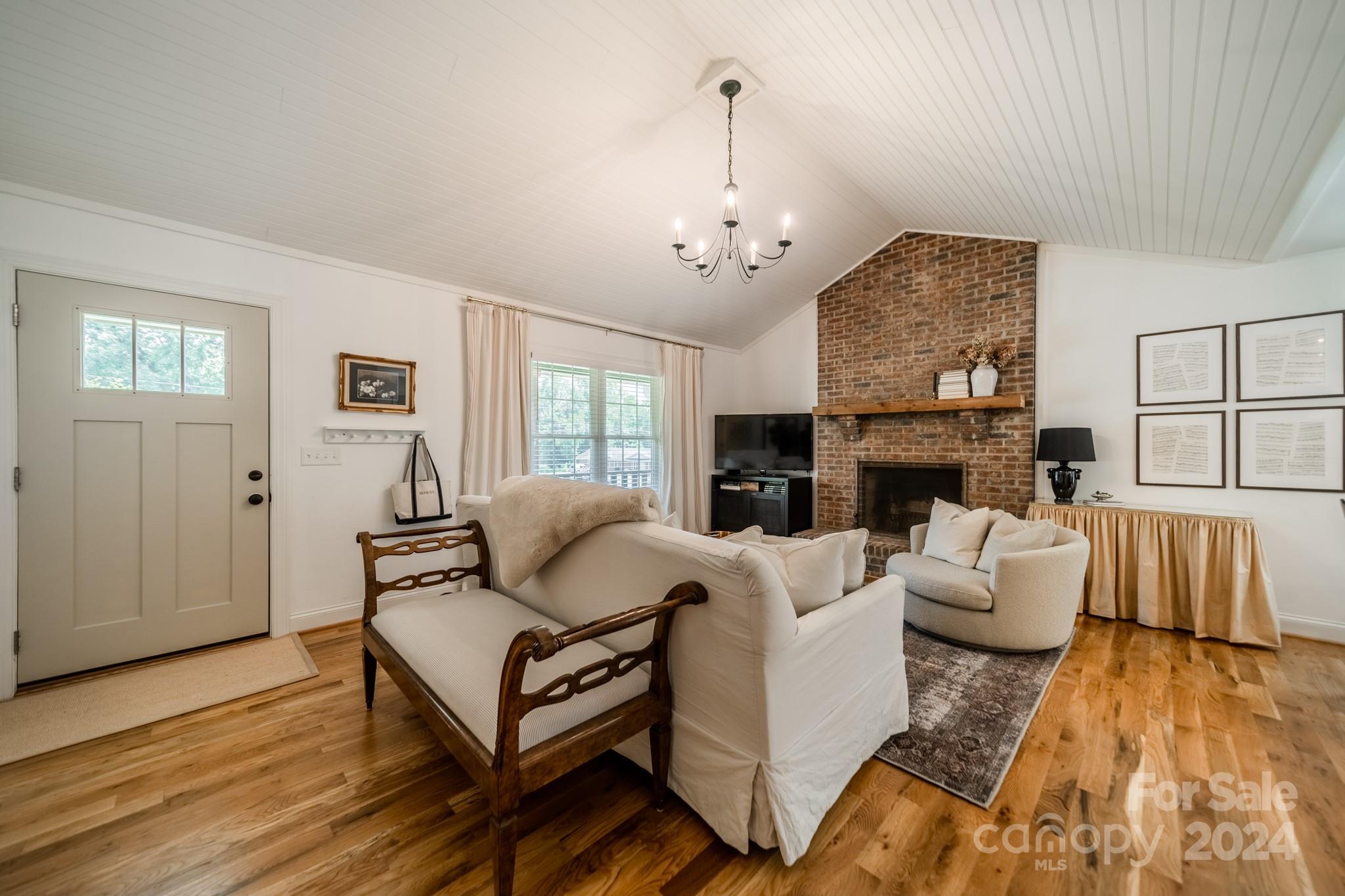 101 North Lane Road Mount Holly, NC 28120 - Photo 13 of 33 a living room with furniture a fireplace and a flat screen tv