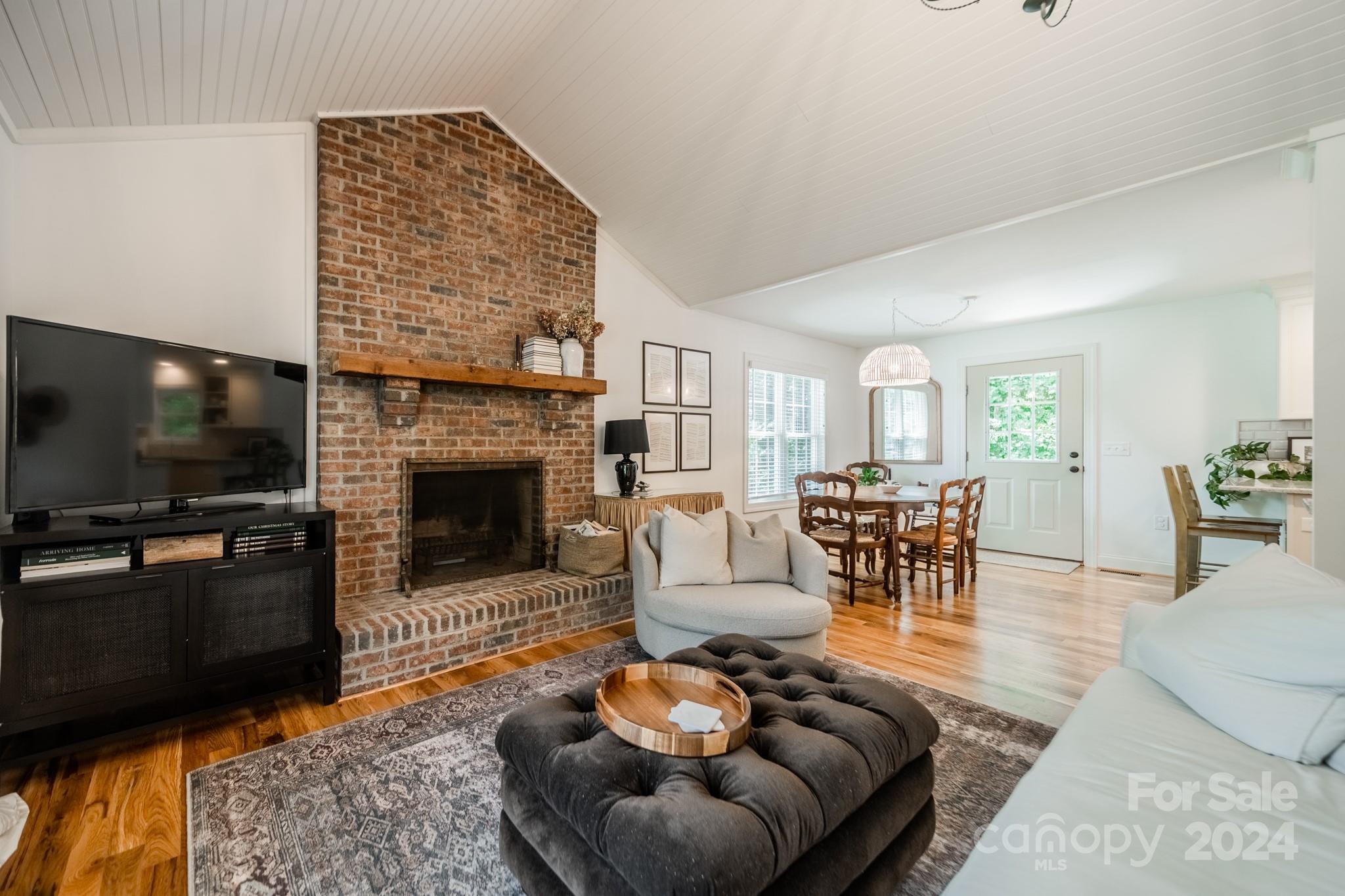 101 North Lane Road Mount Holly, NC 28120 - Photo 16 of 33 a living room with furniture a flat screen tv and a fireplace
