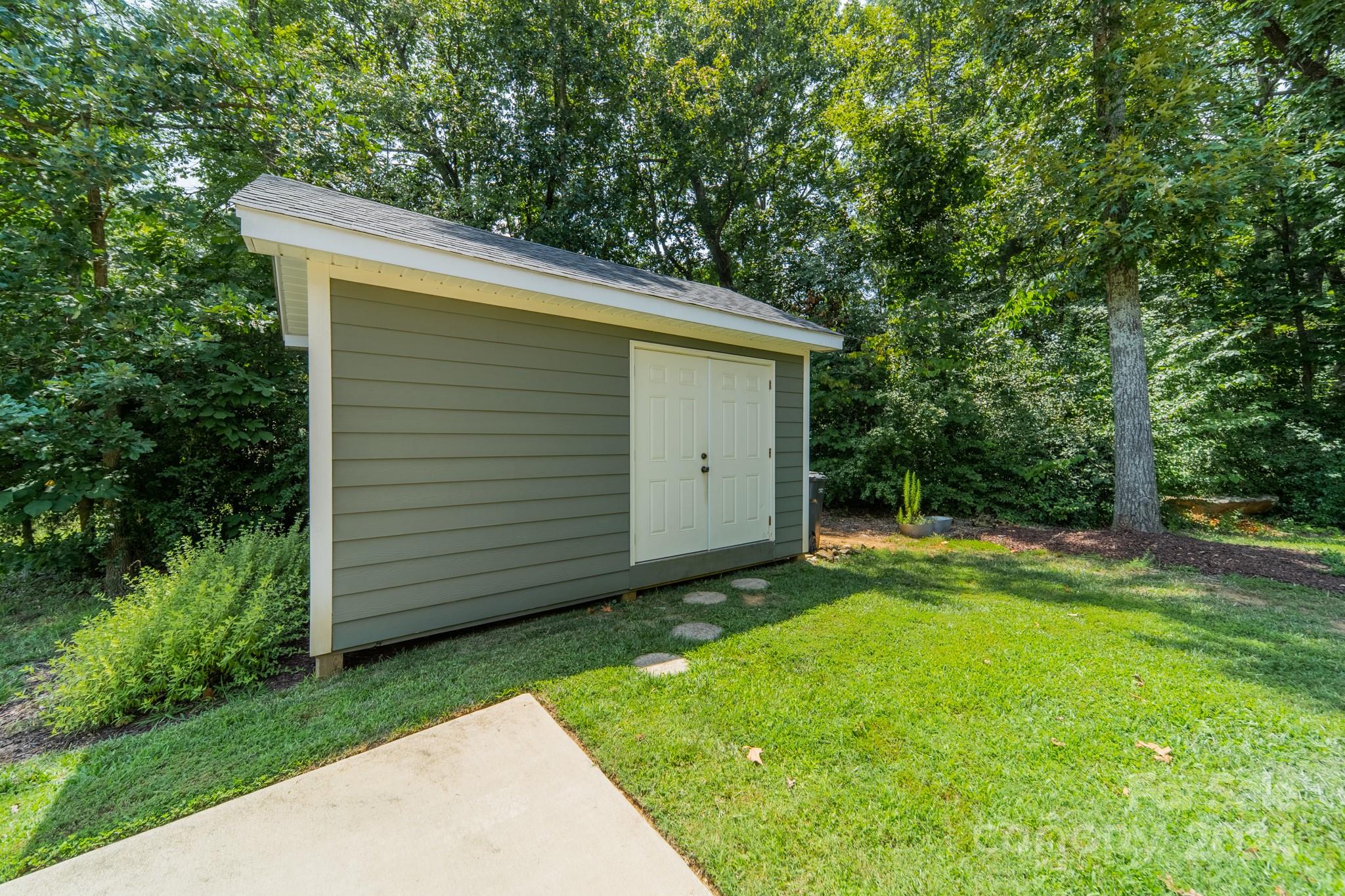 101 North Lane Road Mount Holly, NC 28120 - Photo 28 of 33 a view of backyard with potted plants and large tree