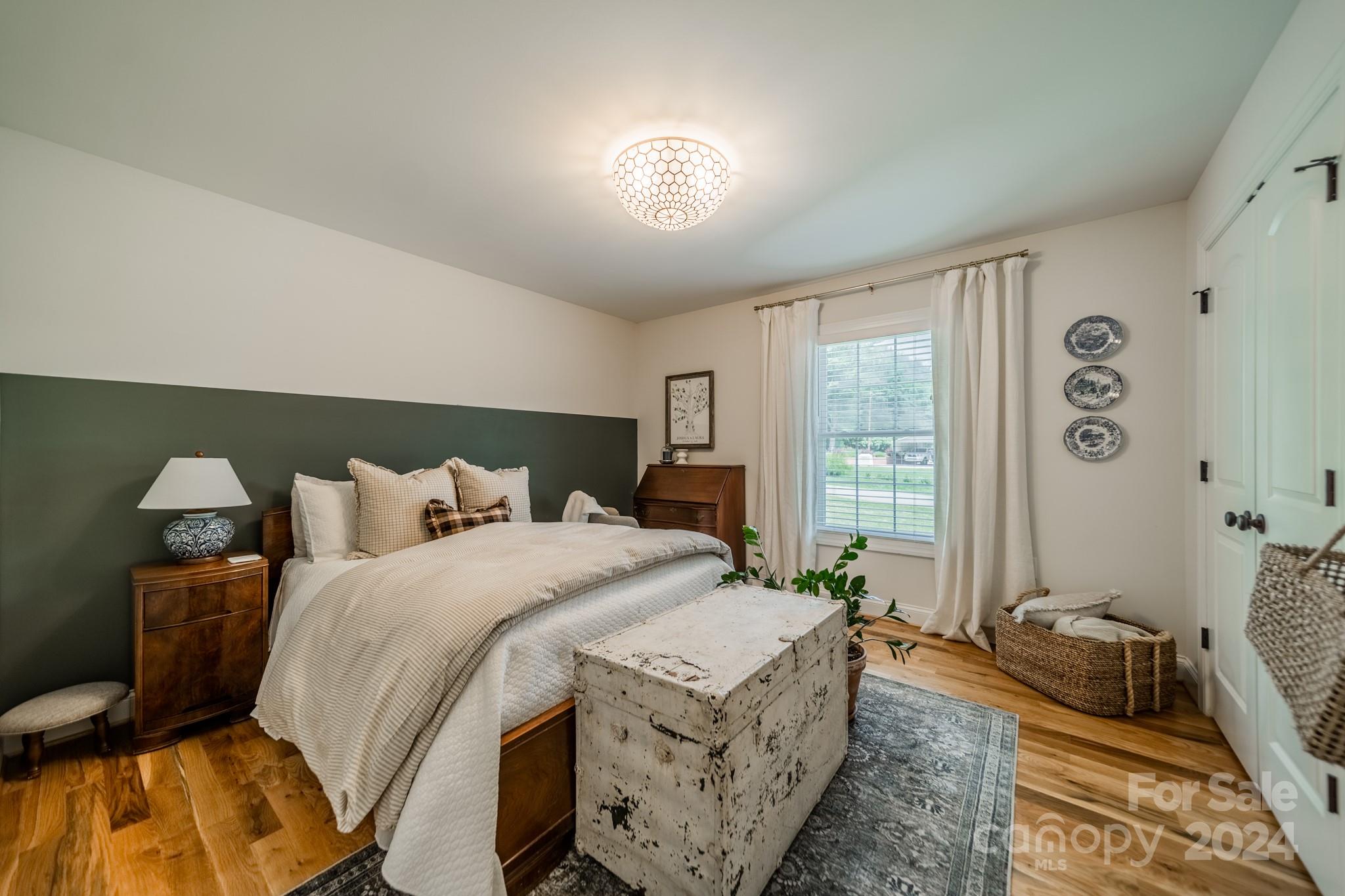 101 North Lane Road Mount Holly, NC 28120 - Photo 6 of 33 a bedroom with a bed and a chandelier