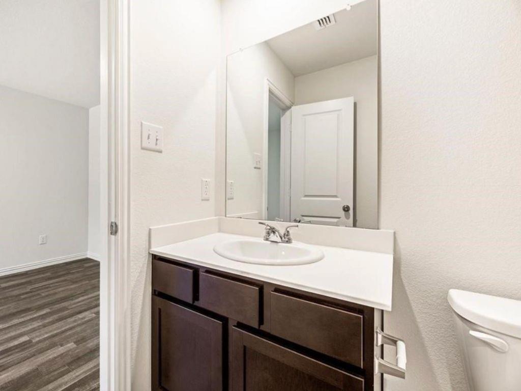 1007 Dawson Street Waco, TX 76704 - Photo 9 of 20 a bathroom with a sink and a toilet