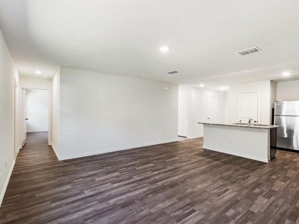 1007 Dawson Street Waco, TX 76704 - Photo 16 of 20 a view of an empty room with wooden floor