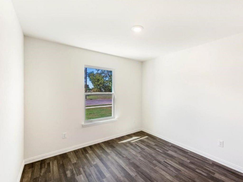 1007 Dawson Street Waco, TX 76704 - Photo 18 of 20 a view of an empty room with wooden floor and a window