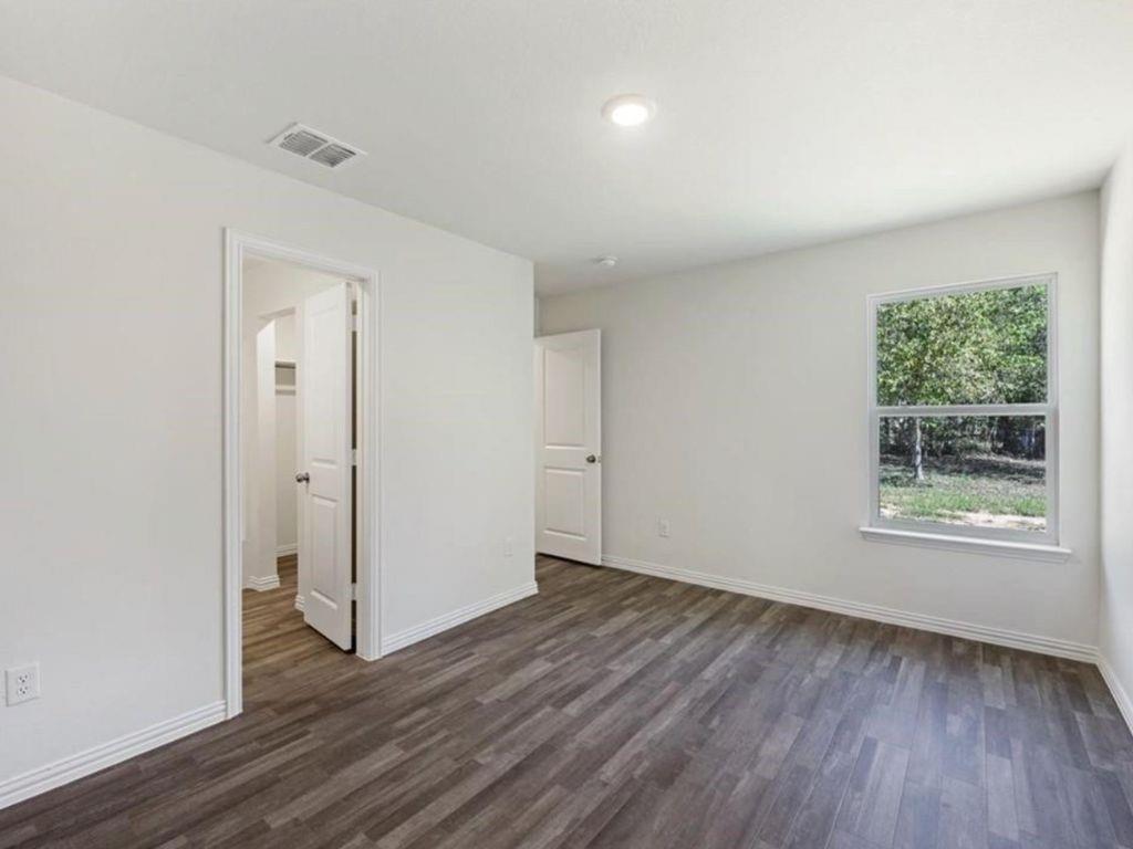 1007 Dawson Street Waco, TX 76704 - Photo 5 of 20 an empty room with wooden floor and a window