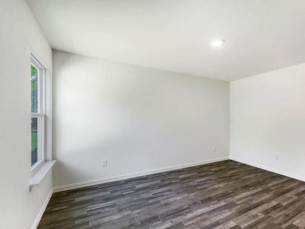 1007 Dawson Street Waco, TX 76704 - Photo 6 of 20 a view of empty room with wooden floor
