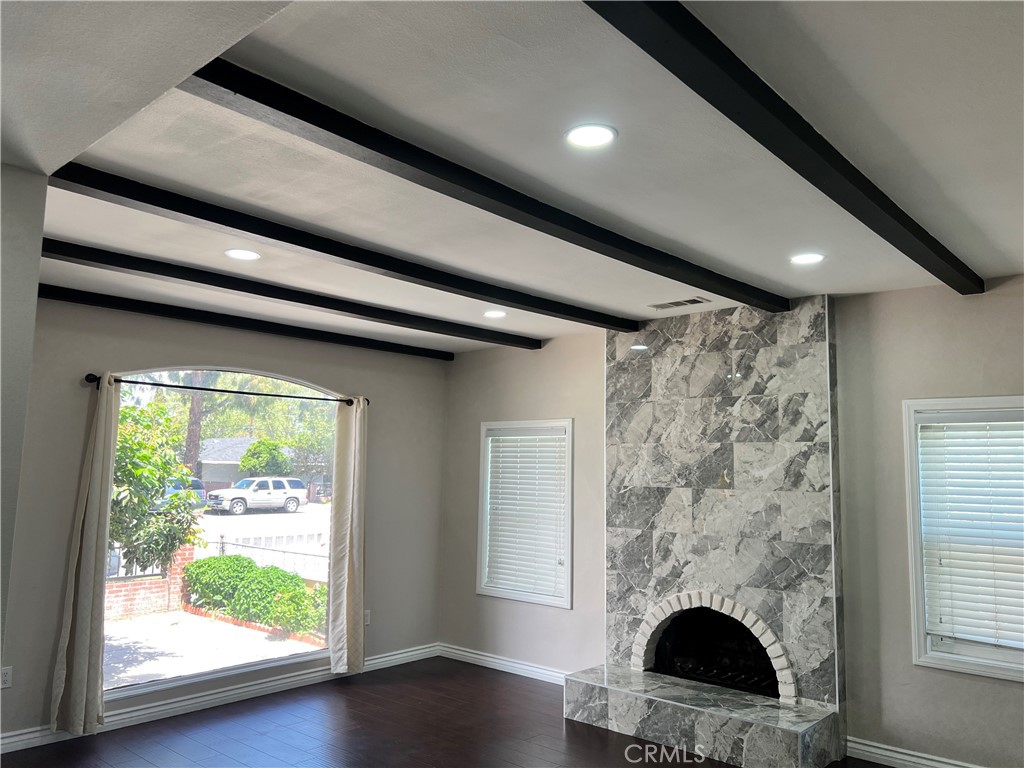 9352 Beverly Road Pico Rivera, CA 90660 - Photo 13 of 35 a living room with a fireplace and a floor to ceiling window