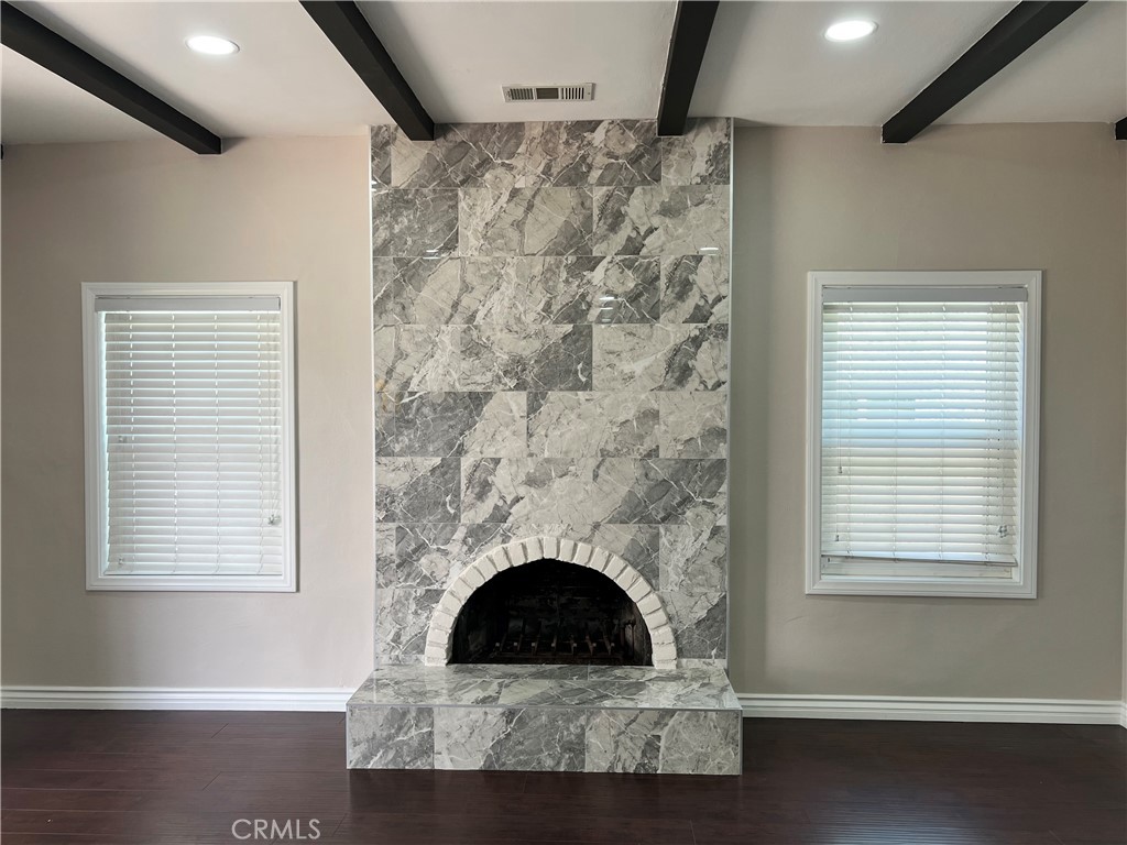 9352 Beverly Road Pico Rivera, CA 90660 - Photo 14 of 35 a living room with a fireplace and windows