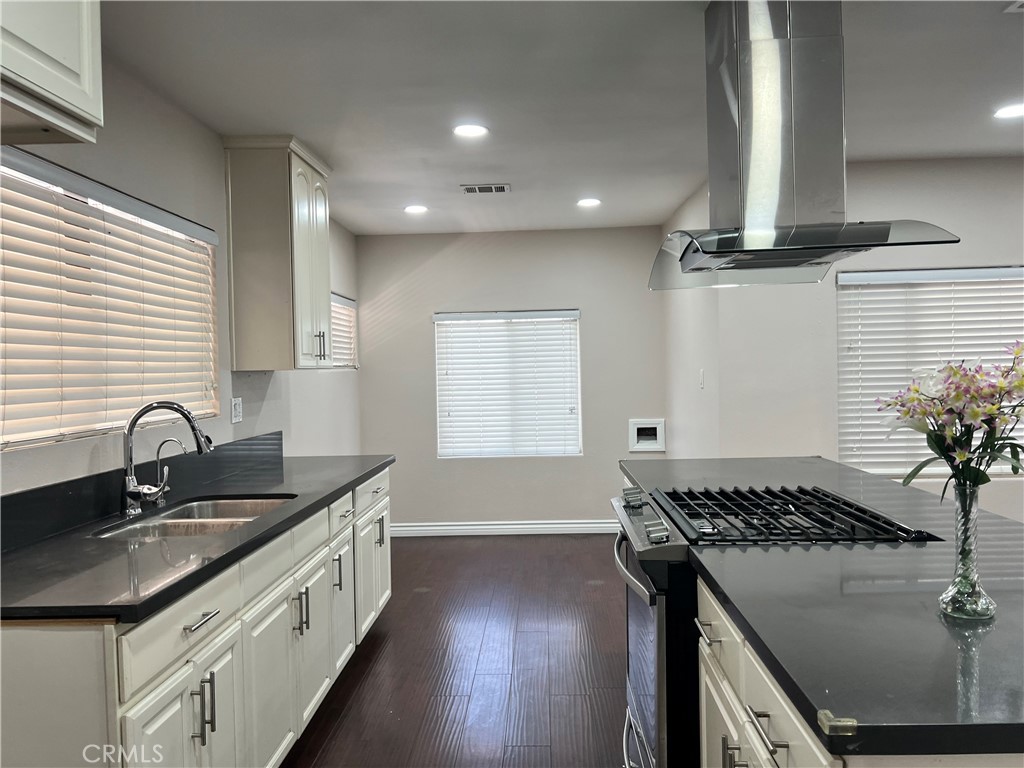 9352 Beverly Road Pico Rivera, CA 90660 - Photo 17 of 35 a kitchen with sink stove and cabinets