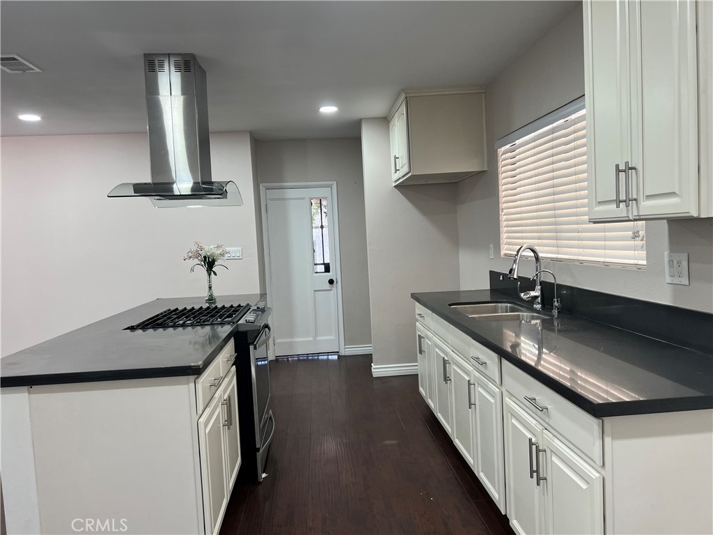 9352 Beverly Road Pico Rivera, CA 90660 - Photo 18 of 35 a kitchen with stainless steel appliances granite countertop a sink stove and cabinets