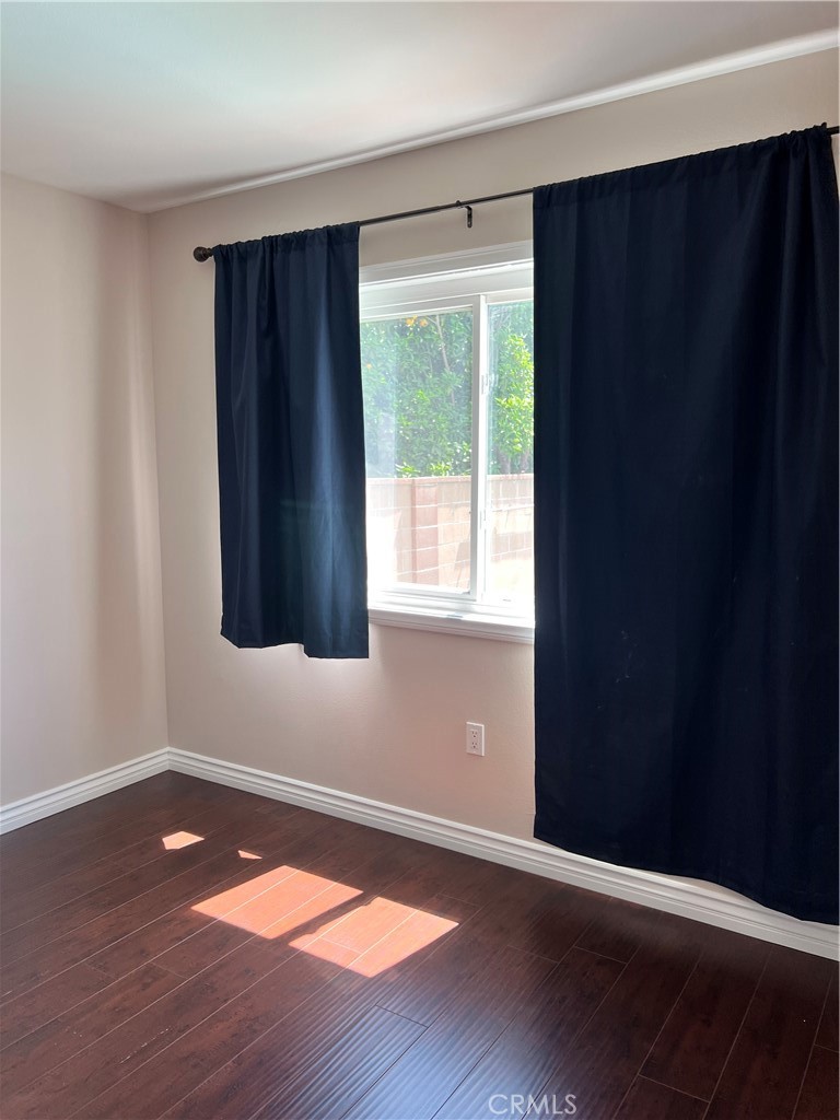 9352 Beverly Road Pico Rivera, CA 90660 - Photo 23 of 35 a view of an empty room with wooden floor and a window