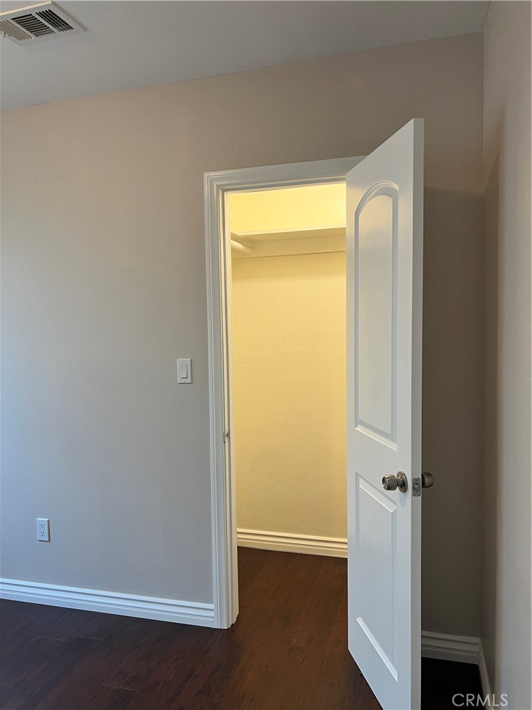 9352 Beverly Road Pico Rivera, CA 90660 - Photo 27 of 35 an empty room with wooden floor and a window