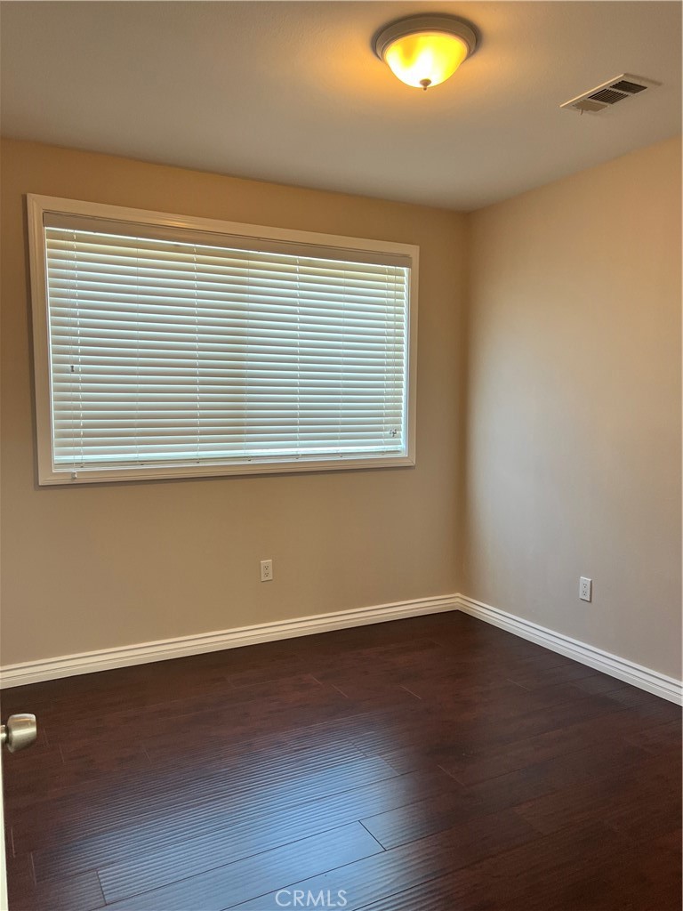 9352 Beverly Road Pico Rivera, CA 90660 - Photo 28 of 35 a view of an empty room with wooden floor and a window