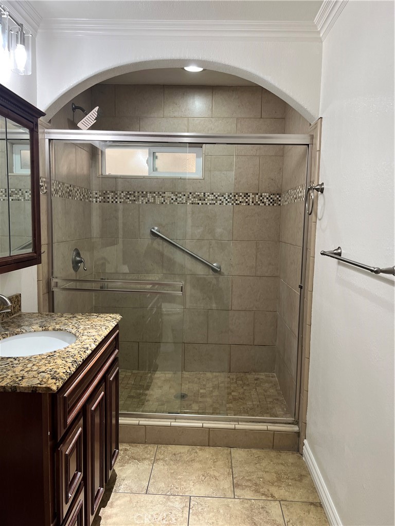 9352 Beverly Road Pico Rivera, CA 90660 - Photo 34 of 35 a bathroom with a granite countertop sink a mirror and shower