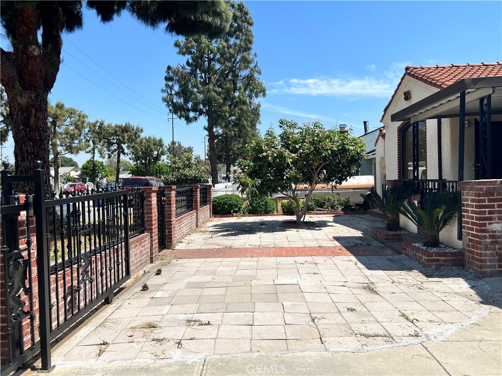 9352 Beverly Road Pico Rivera, CA 90660 - Photo 4 of 35 a view of a pathway with a wrought fence