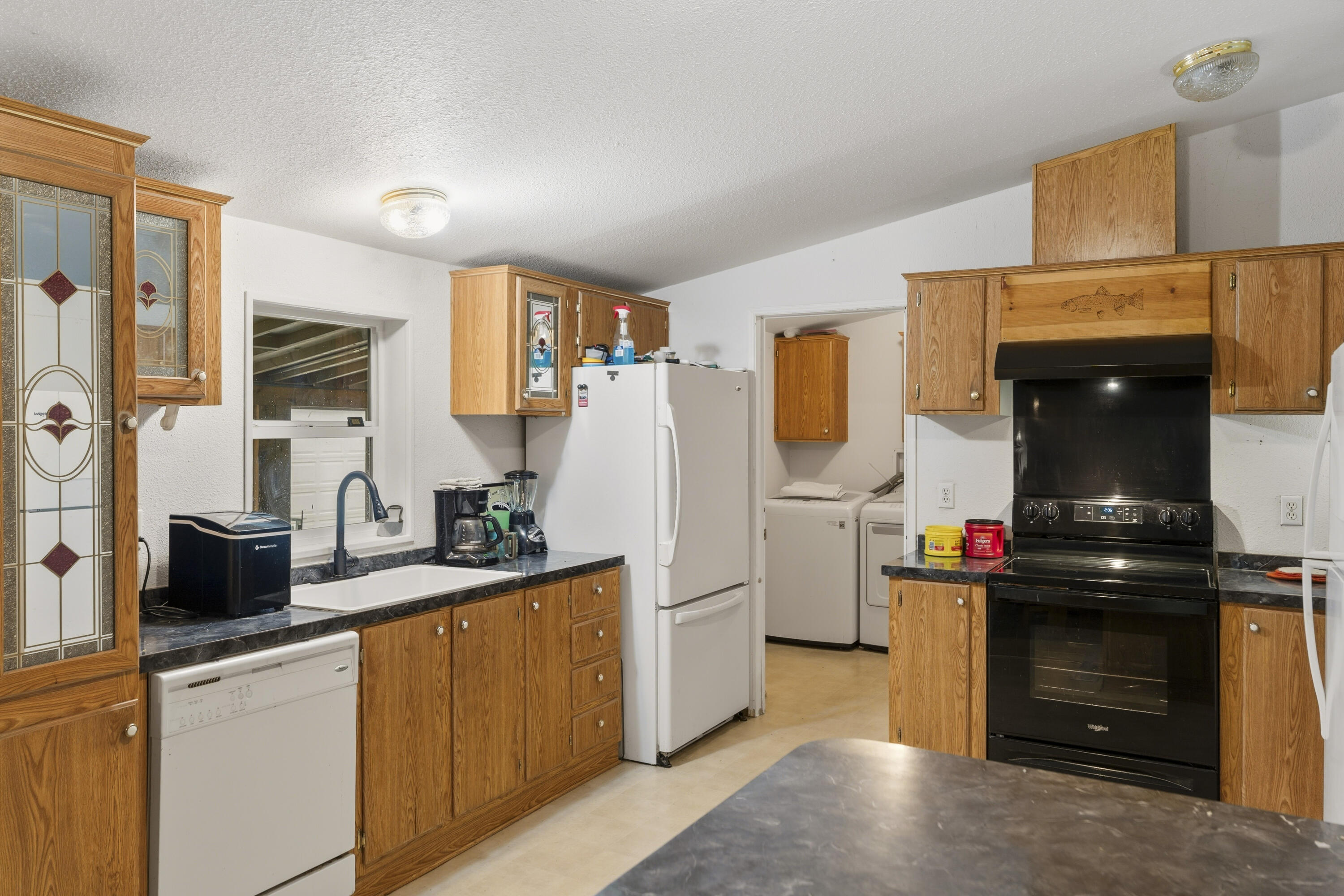 16928 Covina Road Bend, OR 97707 - Photo 12 of 48 a kitchen with a sink stove and refrigerator