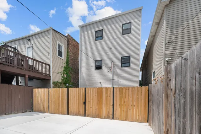 a view of a house with a backyard