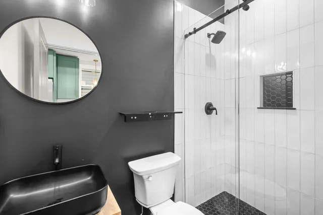 a bathroom with a toilet and a shower