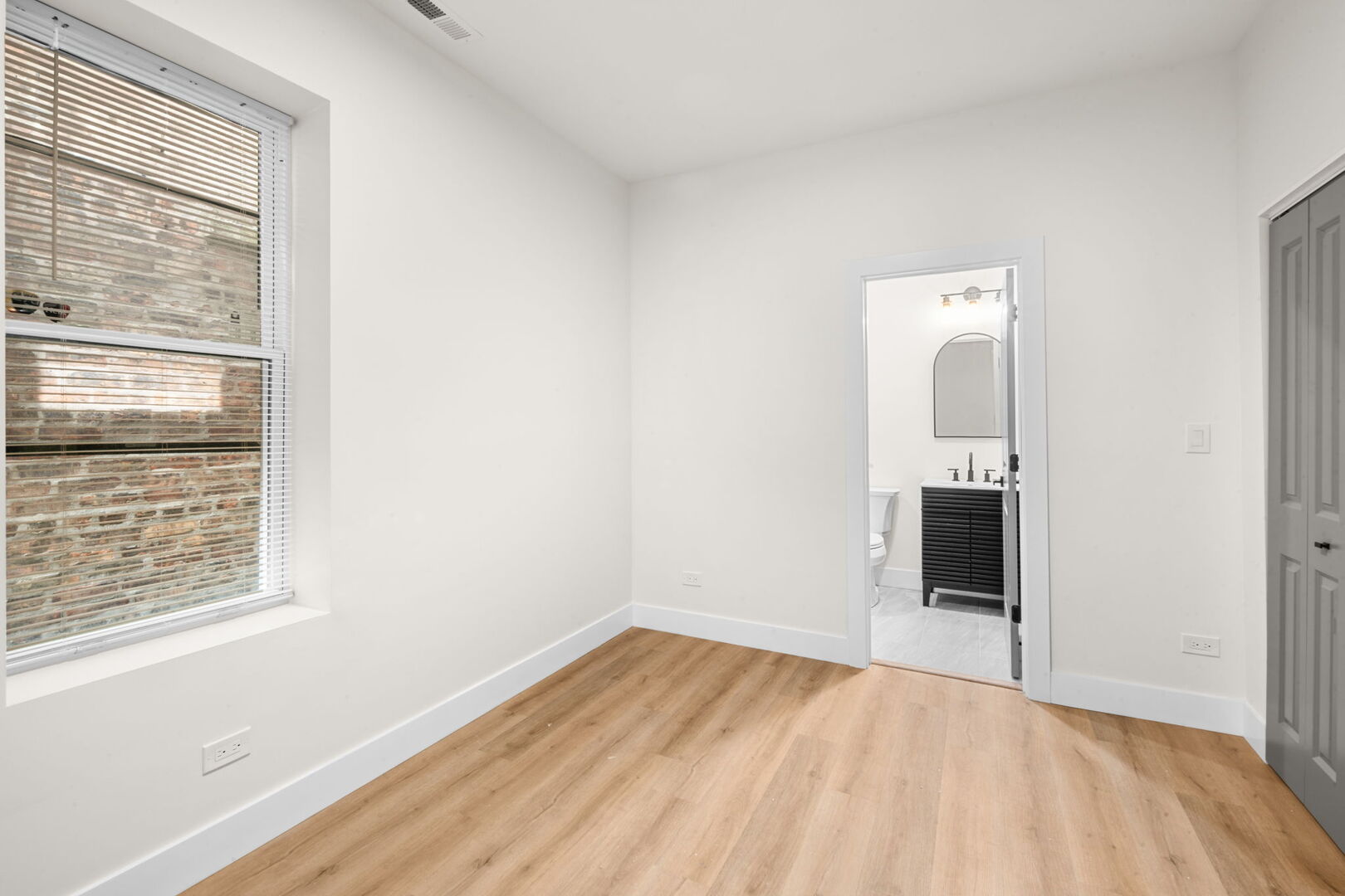 5443 South Federal Street, Unit 2 Chicago, IL 60609 - Photo 5 of 10 a view of an empty room with wooden floor and a window
