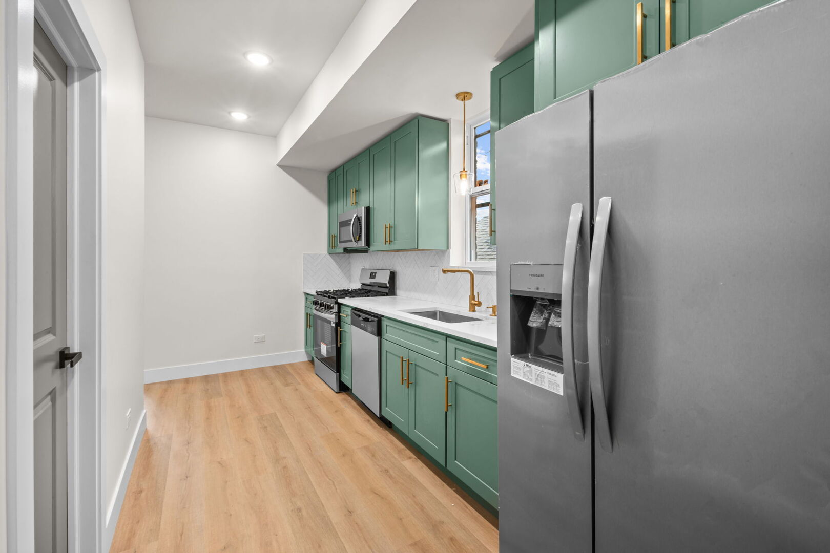 5443 South Federal Street, Unit 2 Chicago, IL 60609 - Photo 7 of 10 a kitchen with stainless steel appliances granite countertop a refrigerator and a sink