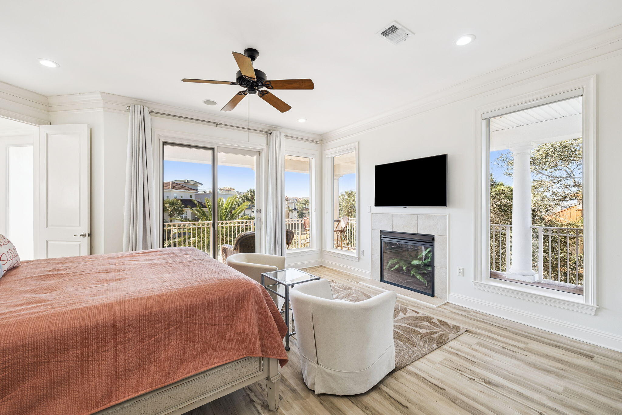 4726 Serendipity Pointe Destin, FL 32541 - Photo 68 of 98 a spacious bedroom with a large bed a flat tv screen and a fireplace