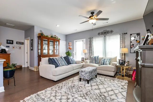 a living room with furniture and a chandelier