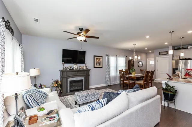 a living room with furniture fireplace and a flat screen tv