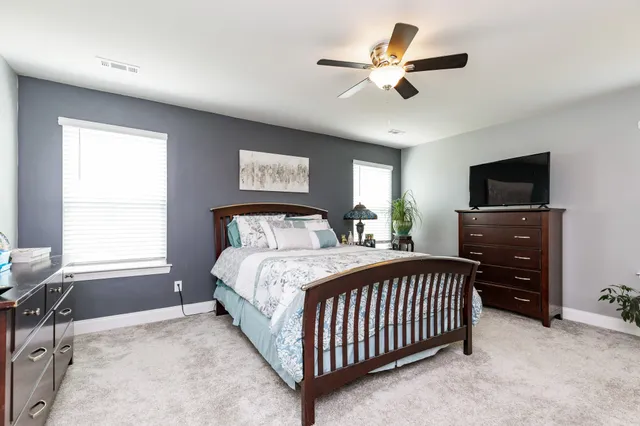 a bedroom with a bed and a tv