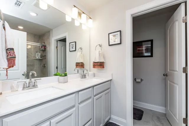 a bathroom with a sink double vanity and a mirror