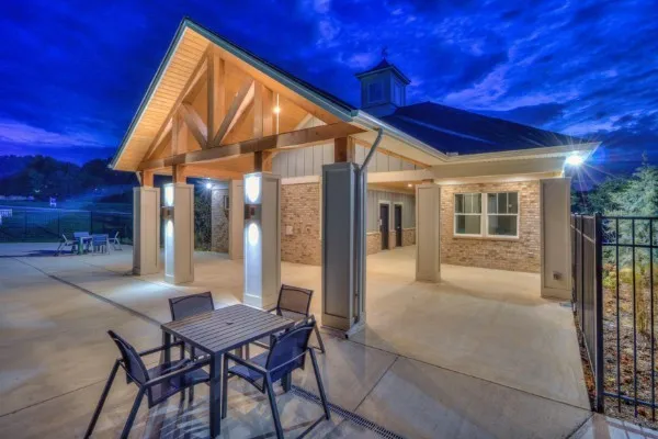 a view of a house with backyard and sitting area