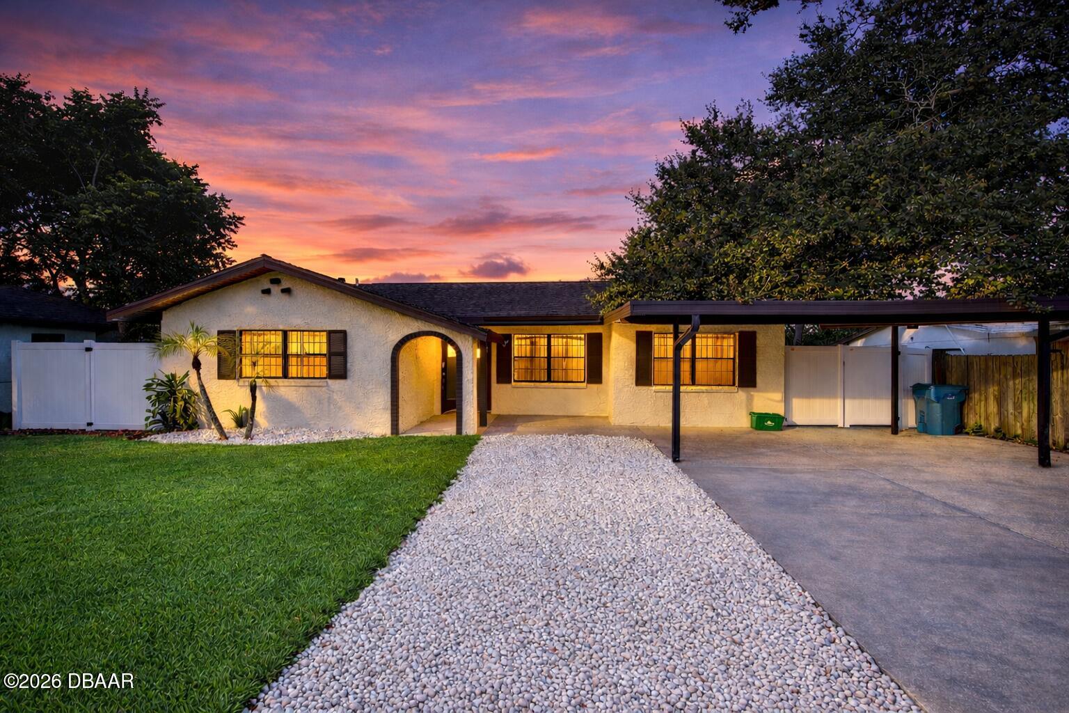 a front view of a house with garden