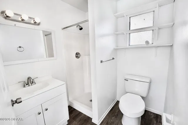 a bathroom with a toilet sink and shower