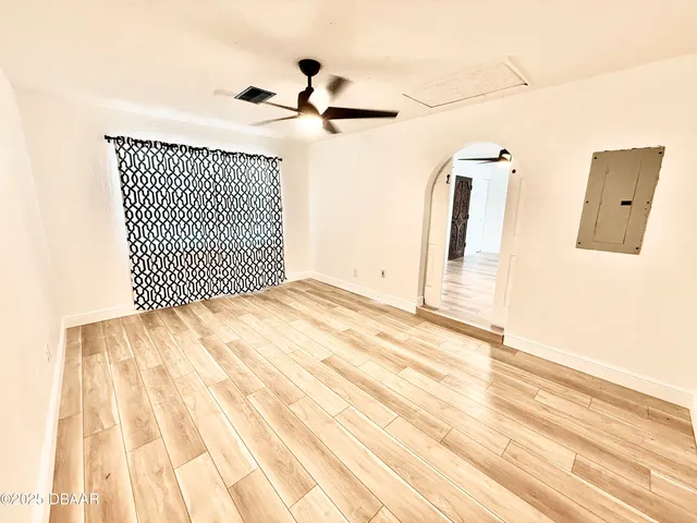 a view of a room with wooden floor and white walls