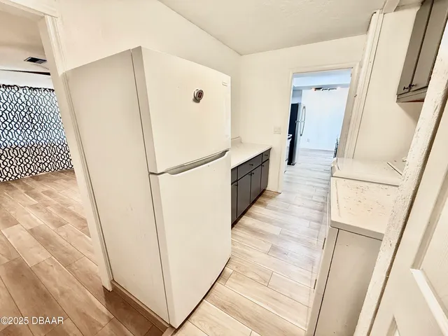 a view of a kitchen from the hallway
