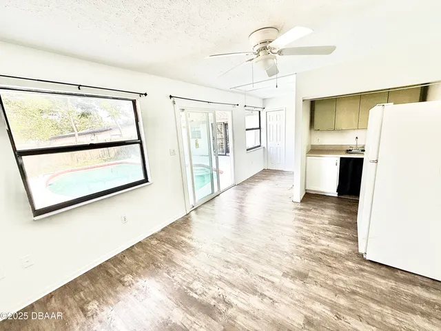 a view of a refrigerator in kitchen and wooden floor