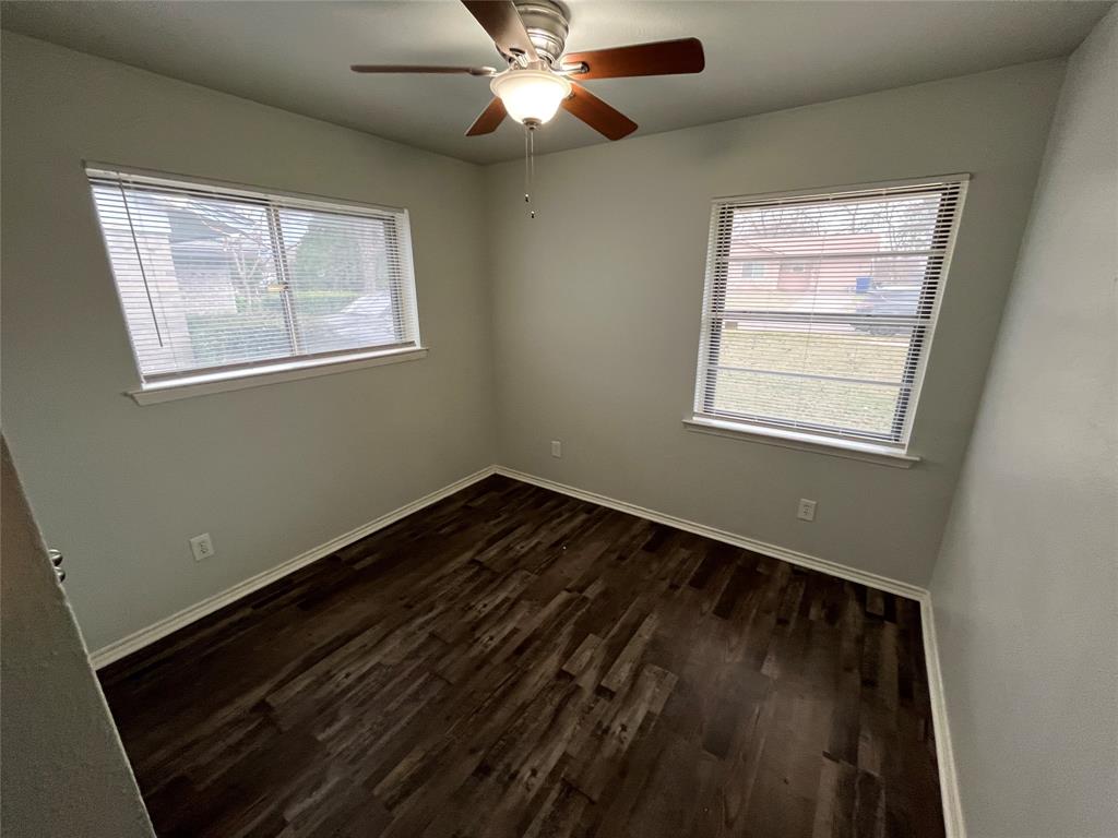 1841 South Perry Road Carrollton, TX 75006 - Photo 16 of 25 Unfurnished room featuring dark wood finished floors and ceiling fan