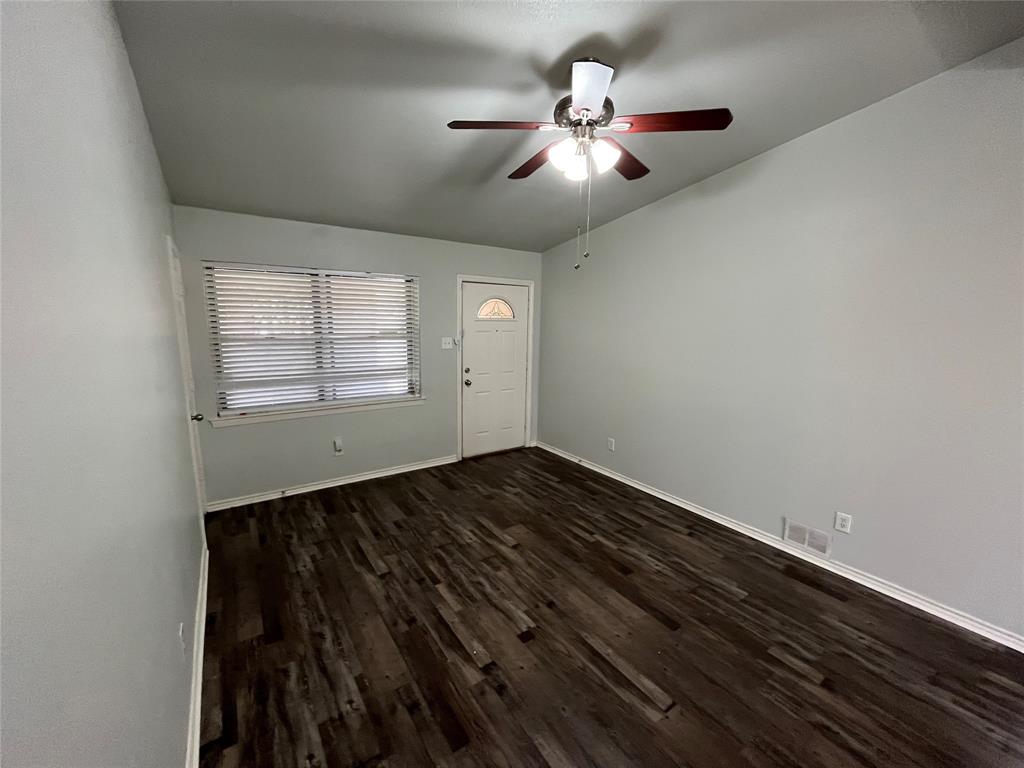1841 South Perry Road Carrollton, TX 75006 - Photo 5 of 25 Entryway with dark wood-style floors and ceiling fan
